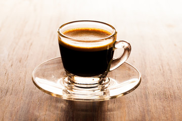 cup of espresso on a wooden background table.