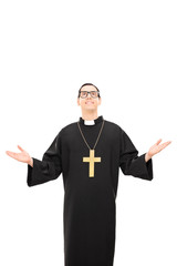 Vertical shot of a young catholic priest looking up