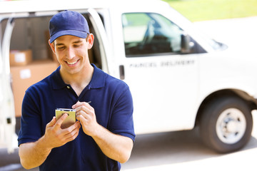 Delivery: Man Tracking Shipment with Van Behind