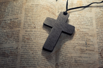 wooden cross on a old bible