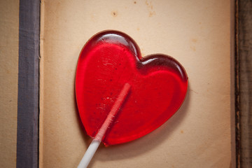 Lollipop heart on vintage wooden background