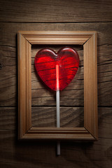 Lollipop heart on vintage wooden frame