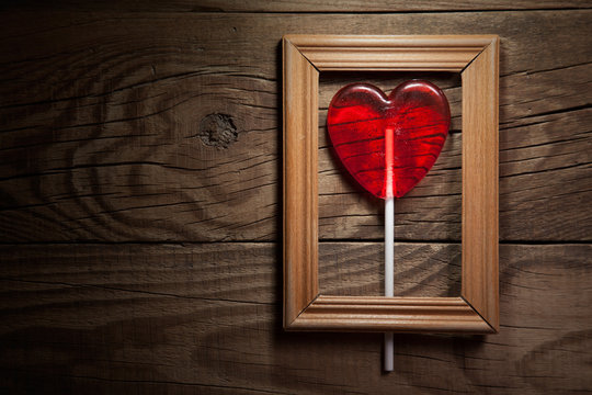 Lollipop heart on vintage wooden frame