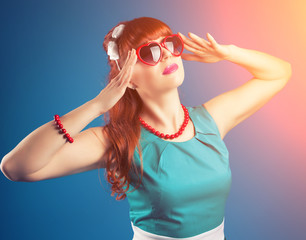 beautiful pin-up girl posing with red heart-shaped sunglasses ag
