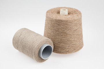 Bobbin with flax, isolated on white background