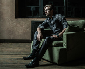 Businessman sitting on an armchair