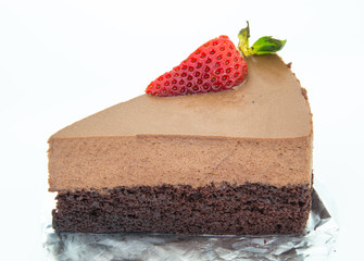 piece of chocolate cake of two layers with fresh strawberries on