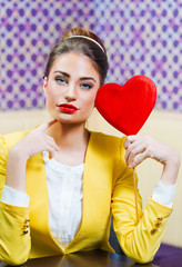Beautiful woman holding a red heart