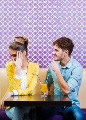 Cute young couple sitting at the table