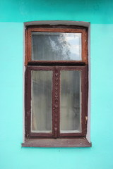 Brown window on a green wall