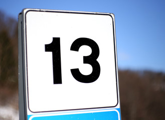 number 13 in a road sign in mountain
