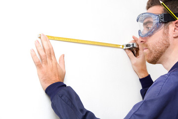 Man measuring a wall