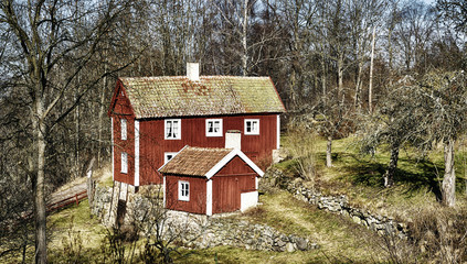 old antique cottage set in a rural landscape surrounding