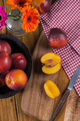 fresh nectarine peach cut on rustic board