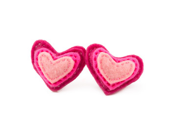 Pair of wool hearts with pink and red stripes on white