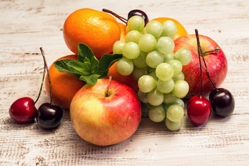 Juicy fruit on a white wooden background