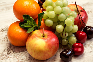Juicy fruit on a white wooden background