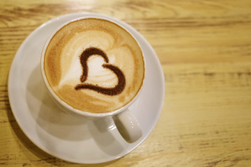 Coffee cup with milk and heart shape