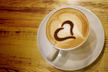 Coffee cup with milk and heart shape
