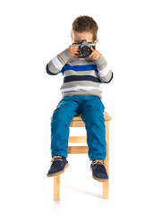 Kid photographing over white background