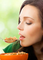 Woman eating muesli or cornflakes