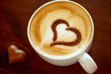 Coffee cup with milk and heart shape