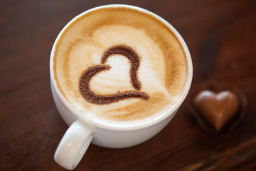 Coffee cup with milk and heart shape