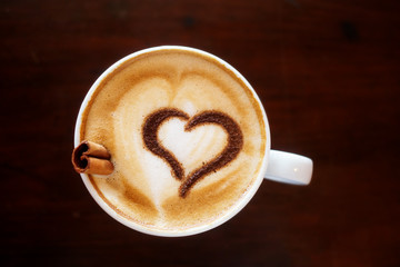 Coffee cup with milk and heart shape