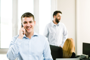 Business Team, young businessman talking on the phone. Selective