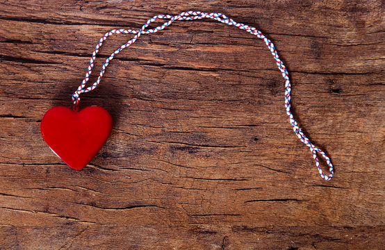 Red heart on old wooden table