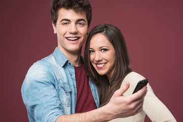 Young teen couple with smartphone