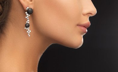 woman wearing shiny diamond earrings