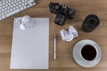 Desktop with camera blank sheet and coffee