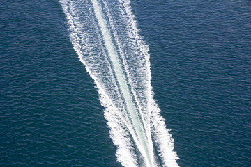 Speed boats trace on the blue sea