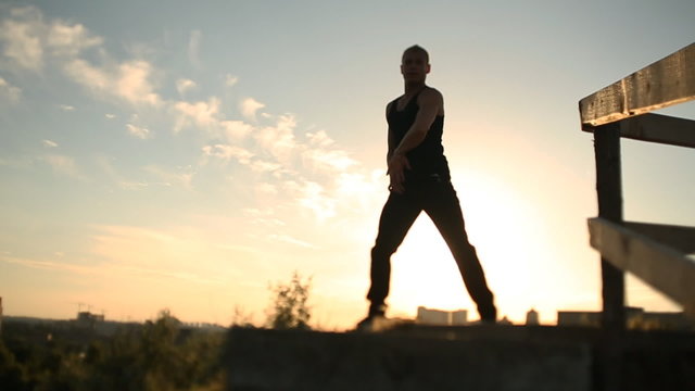 Man dancing at sunset