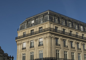 Fototapeta na wymiar Grand apartment block in Europe, against a deep blue sky