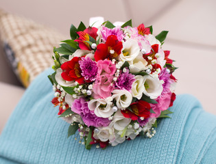 wedding saturate bouquet of different flowers of bride on sofa