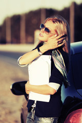 Fashion business woman with financial papers at the car