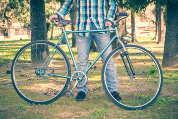 Man with old bike and plaid shirt