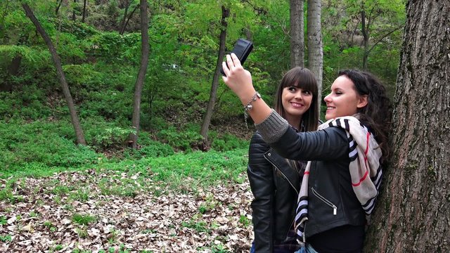Taking selfie with smartphone by two teen girls