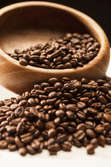 Closeup Image of Woden Bowl With Roasted Coffee Beans Over Blac