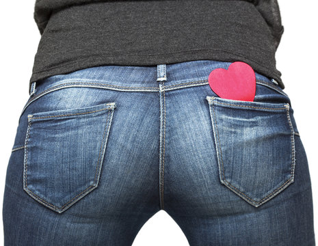 Girl's bum with red paper heart in her jeans pocket