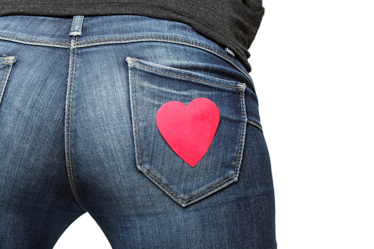 Girl's bum with red paper heart on her jeans pocket
