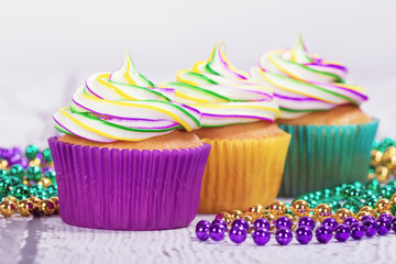 Colorful Mardi Gras cupcakes and beads