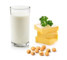 milk with soy beans and stick of butter on white background