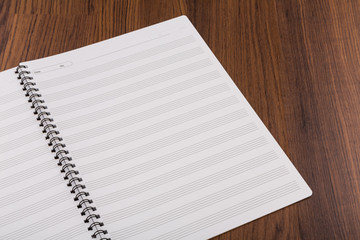 Blank musical notes book mock up on wood background