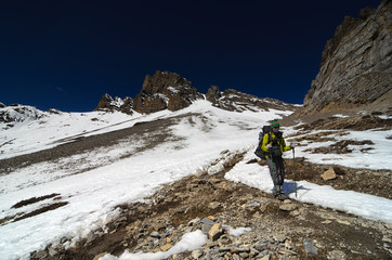 Trekker hiking in snowy mountains