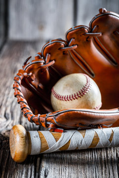 Old baseball bat and glove with ball