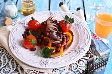 Bruschetta with salad vegetables and octopus