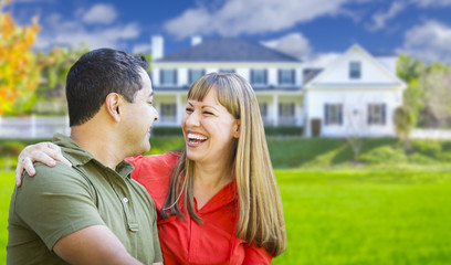 Happy Mixed Race Couple in Front of House